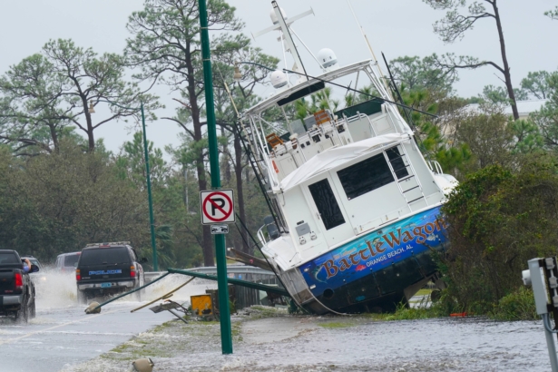 A boat is washed up near a road