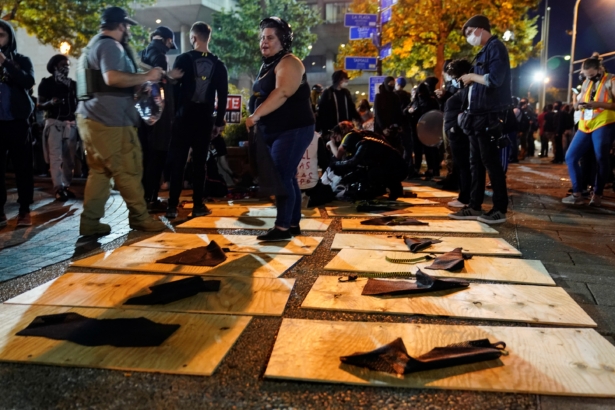 People prepare plywood shields for a march in Louisville