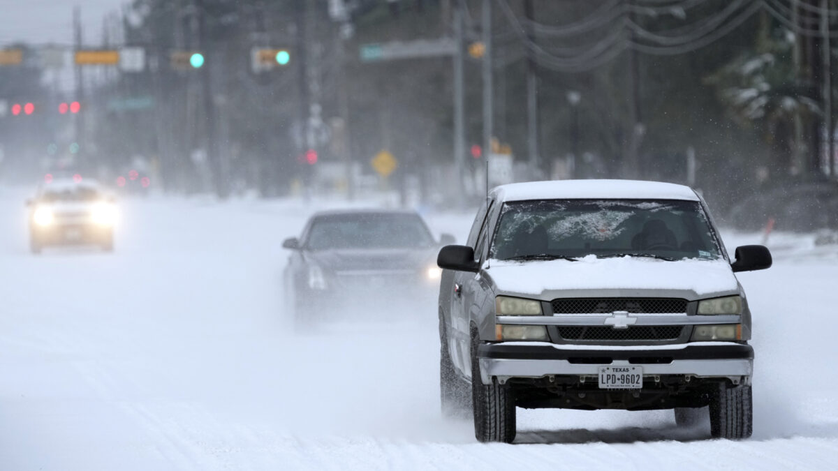 Vehicles drive on snow and sleet