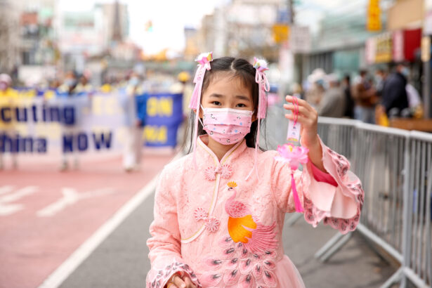 A young Falun Gong practitioner takes part in a parade