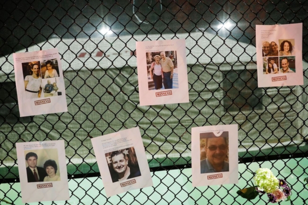 Pictures of missing people and flowers hang on a fence at the memorial for victims of a partially collapsed residential building as the emergency crews continue search and rescue operations for survivors, in Surfside, near Miami Beach, Fla., on June 25, 2021. (Octavio Jones/Reuters)