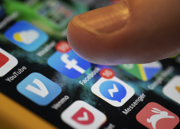 An iPhone displays the apps for Facebook and Messenger