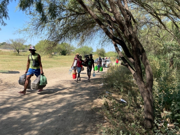 People carry supplies from Acuna