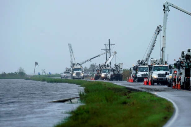 Utility crews replace power poles