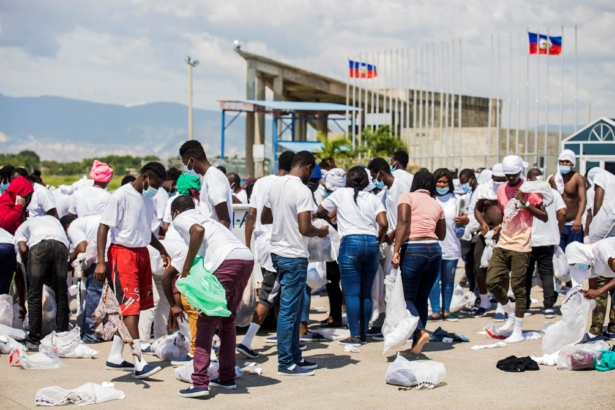 Haitian nationals collect their belongings