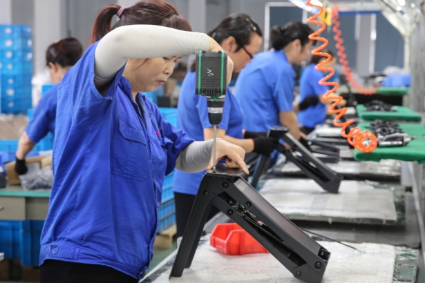 Workers produce desks for export