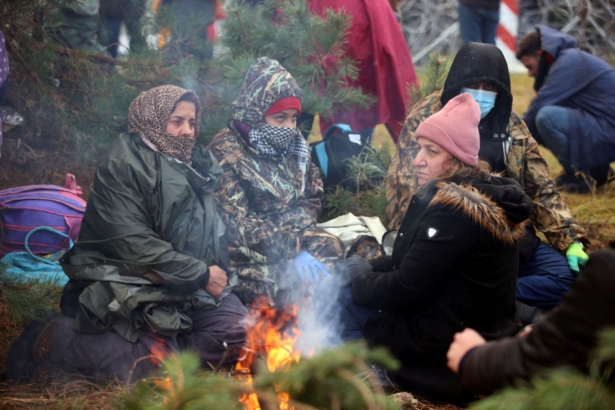Migrants around a fire-border with Poland